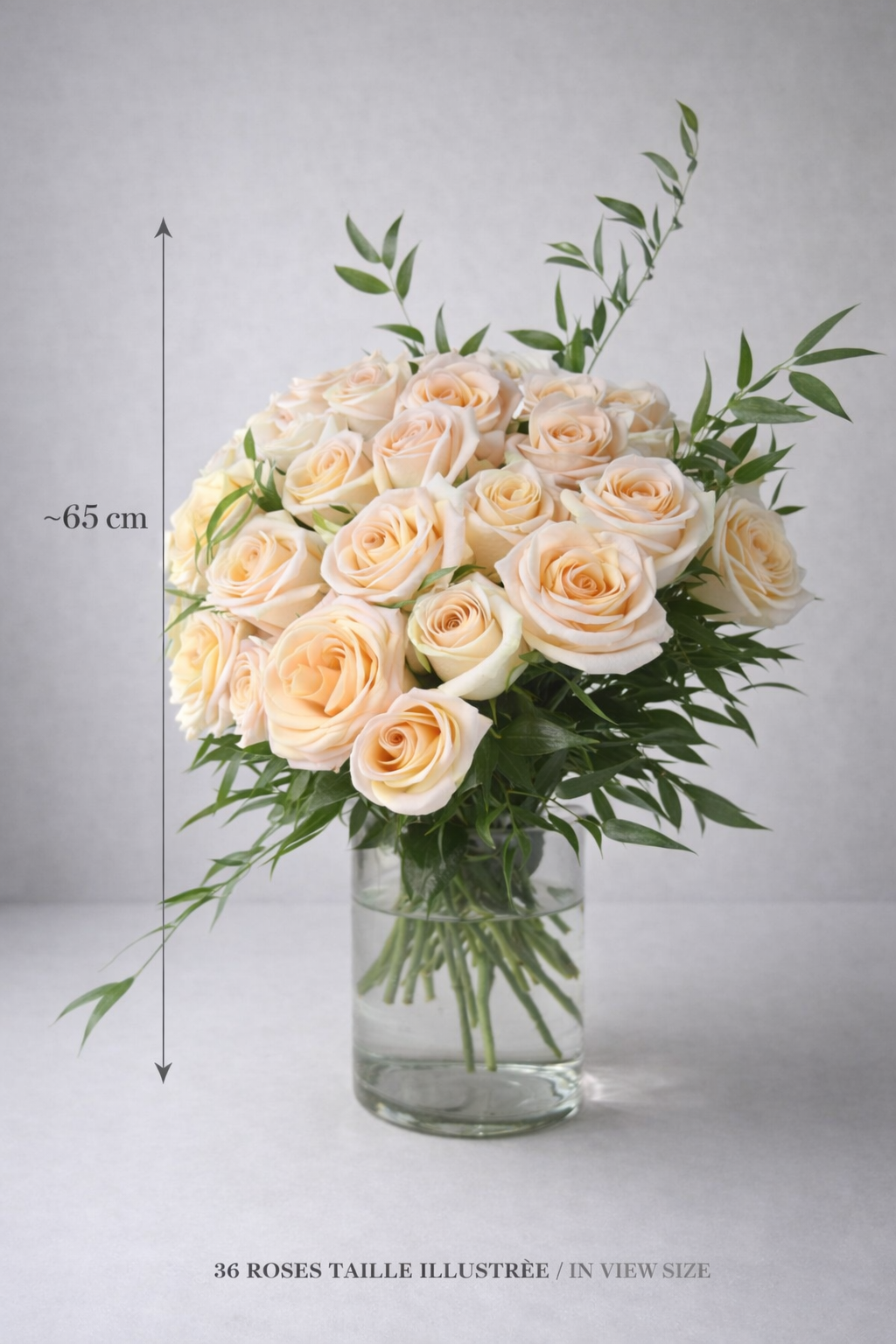 Peach rose bouquet in a clear glass vase with approximate 65 cm height reference and illustrated size note.
