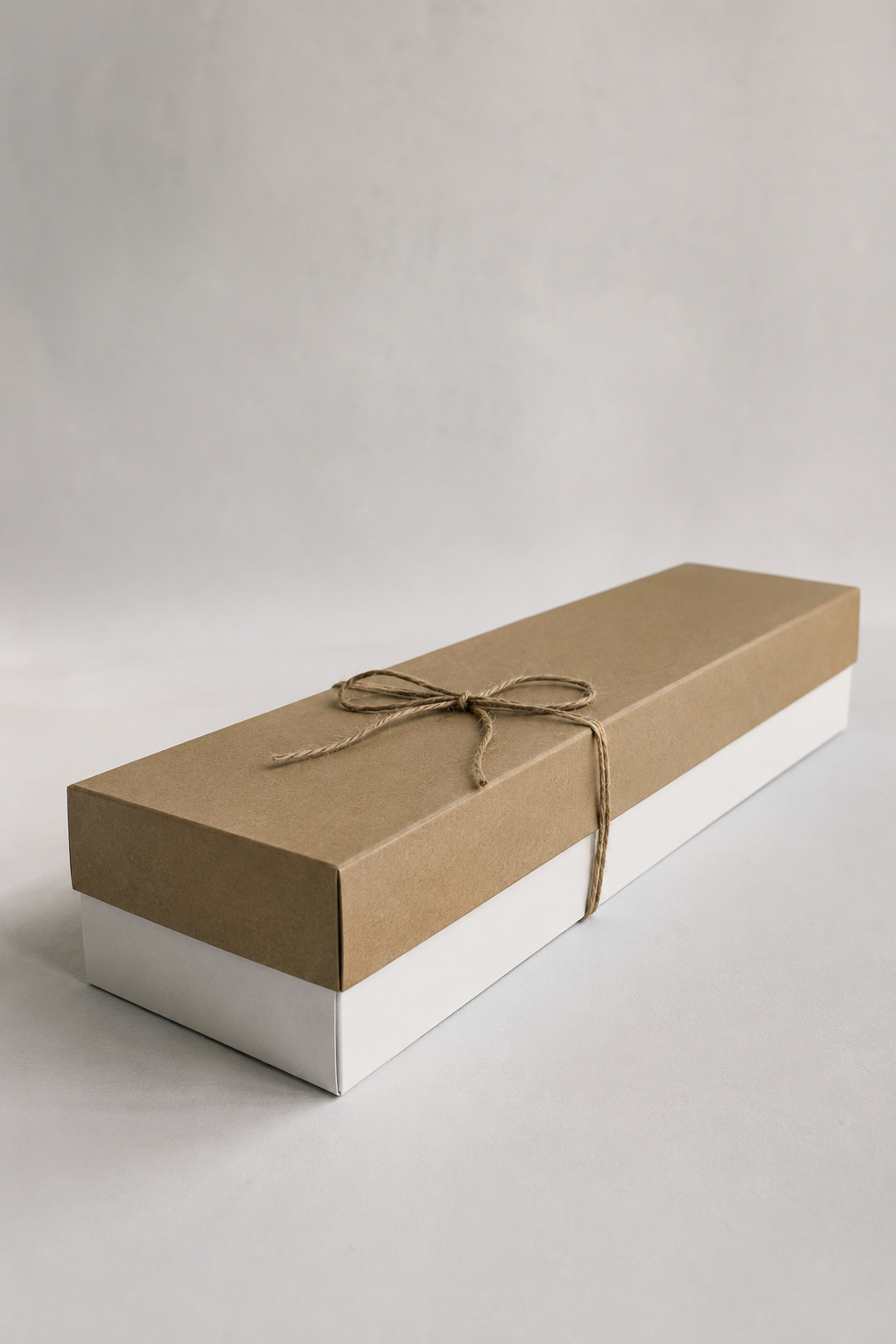 Luxury red rose gift box with 12 roses, deep green foliage, white carton base, and natural brown lid, styled as a premium bouquet Montreal product image.