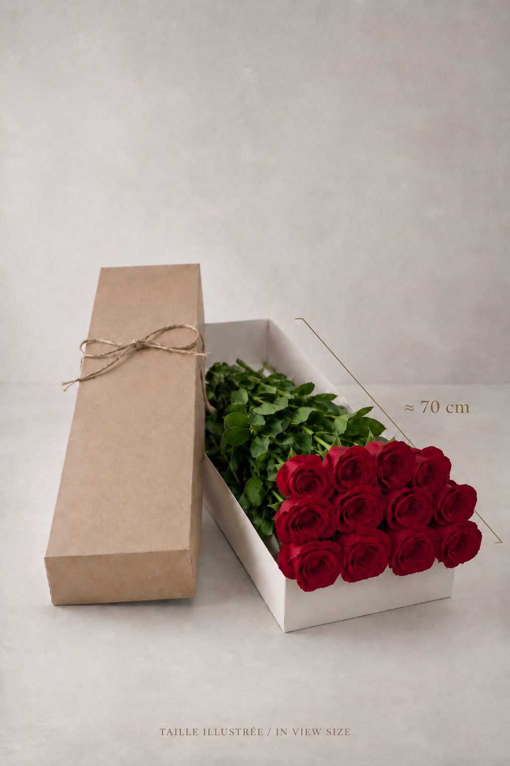 Twelve red roses in a slim white presentation box with a brown lid, shown with an elegant 70 cm size reference for a premium bouquet Montreal