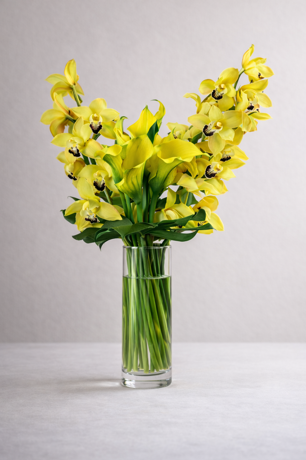 Yellow cymbidium orchid arrangement approximately 80 cm tall displayed in warm contemporary living room, Montreal florist