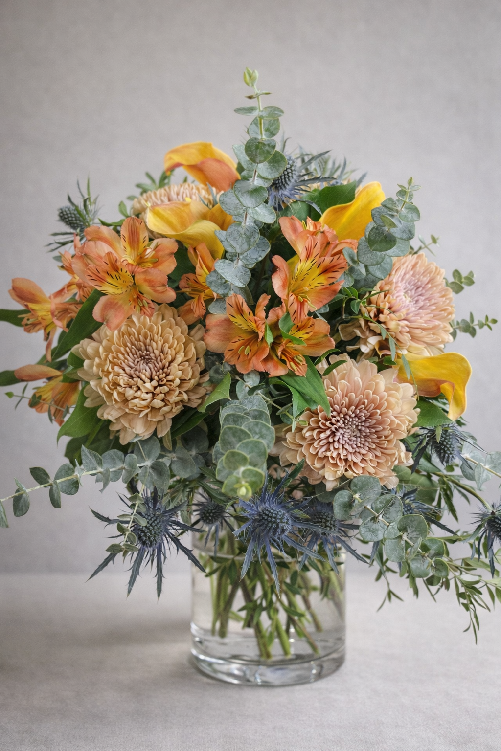 Soft peach floral arrangement with alstroemeria and chrysanthemums in a glass vase, get well soon flowers for hospital delivery in Montreal, designed to bring warmth and comfort