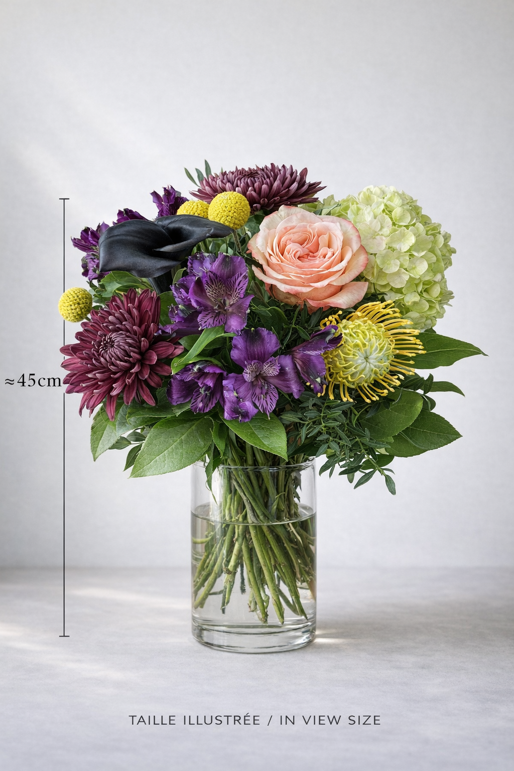 Luxury mixed bouquet in a clear glass vase with approximate 45 cm size indication, featuring peach rose, dark calla lily, burgundy chrysanthemums, purple alstroemeria and green hydrangea.
3. Top view detail