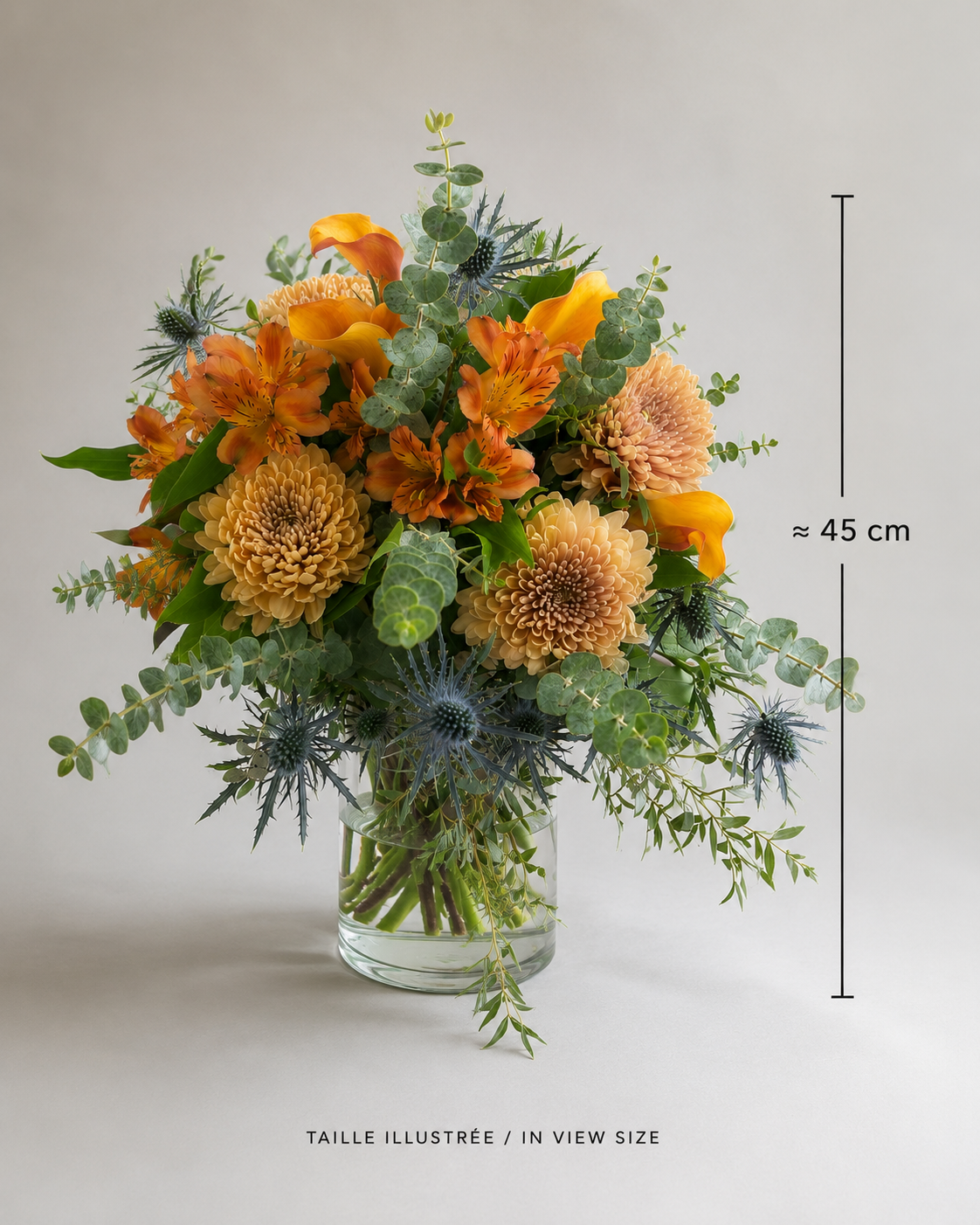 Three-quarter view of a luxury seasonal bouquet with orange, peach and blue flowers in a clear glass vase in Montreal.
