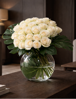 Luxury white roses bouquet 50 cm high in clear glass vase styled in dark contemporary interior, Montreal premium florist