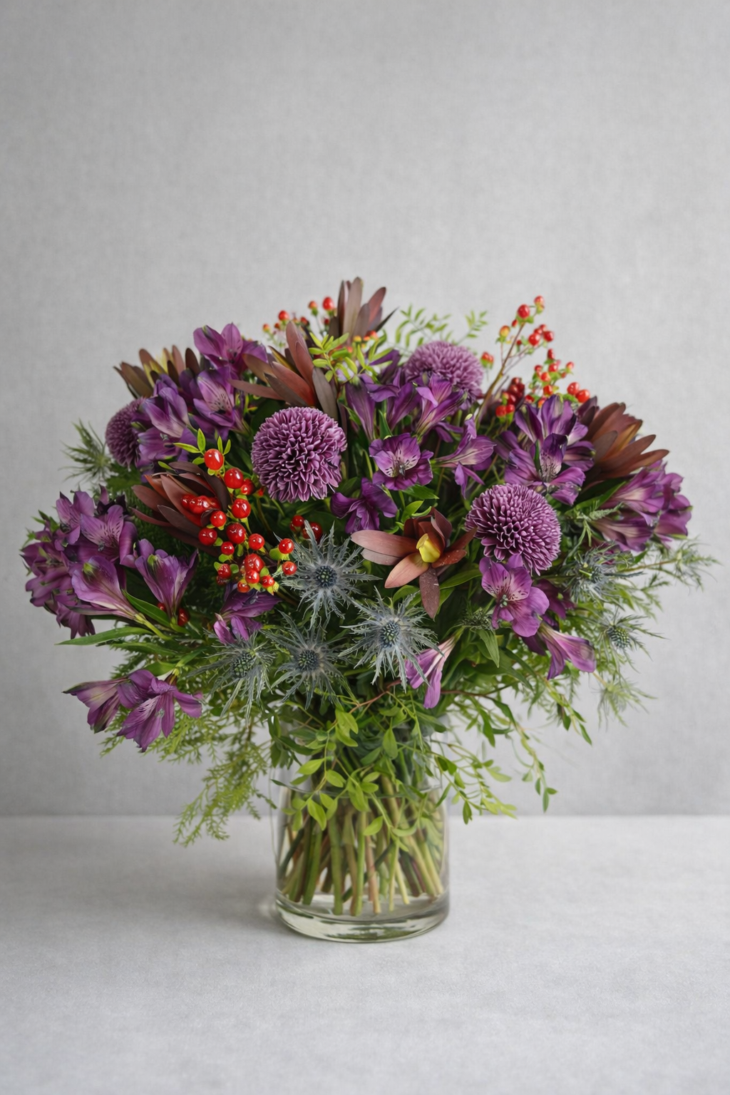 Luxury purple flower bouquet in a clear glass vase by a Montreal florist, styled for elegant flower delivery in Montreal