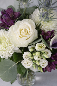 Top view of a luxury white and purple floral bouquet with rose lisianthus calla and foliage in Montreal
