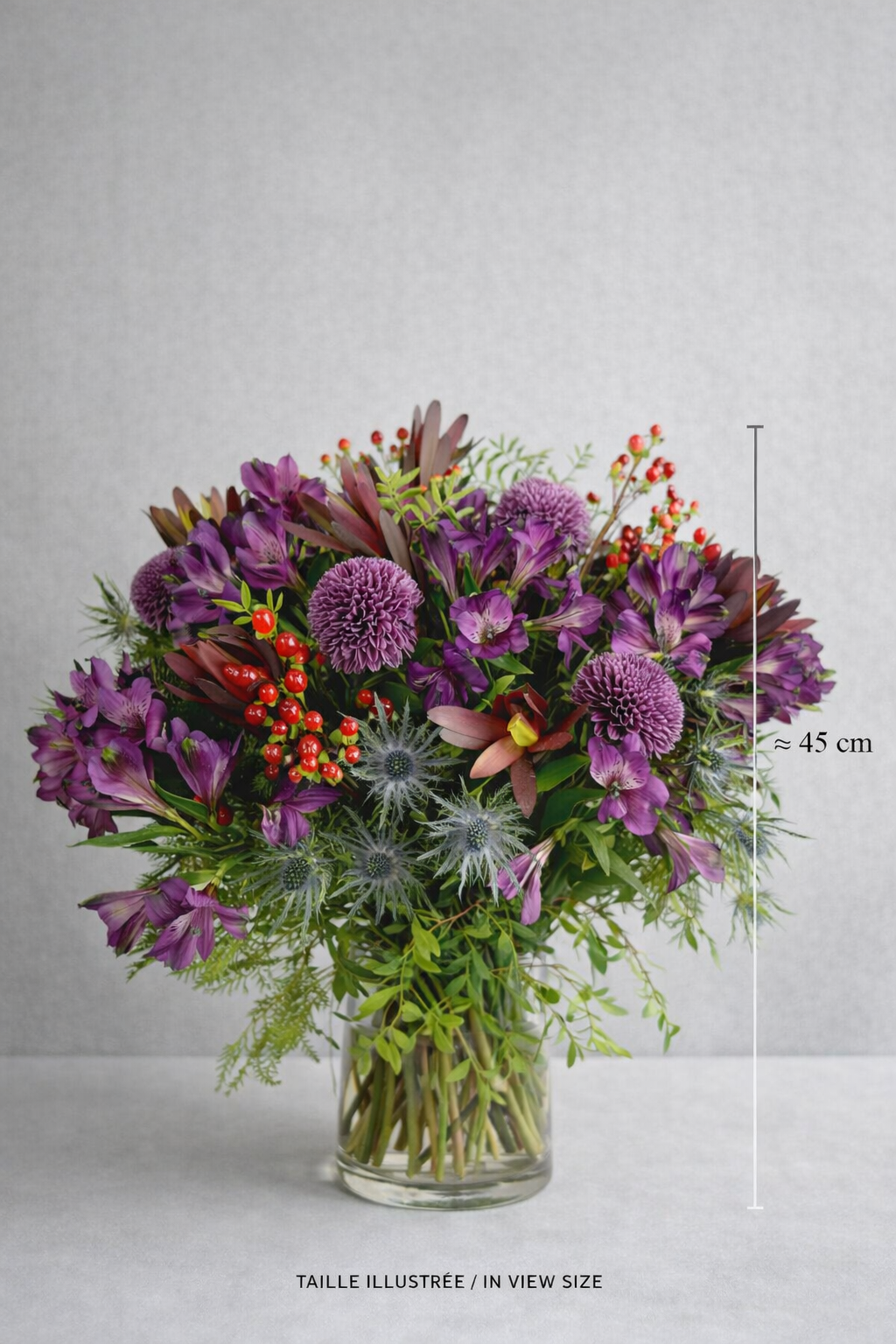 Purple floral arrangement in a clear glass vase, approximately 45 cm tall, available for flower delivery in Montreal
