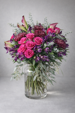 Pink and purple rose bouquet from 3/4 angle in clear vase, natural luxury floral design by Montreal florist.