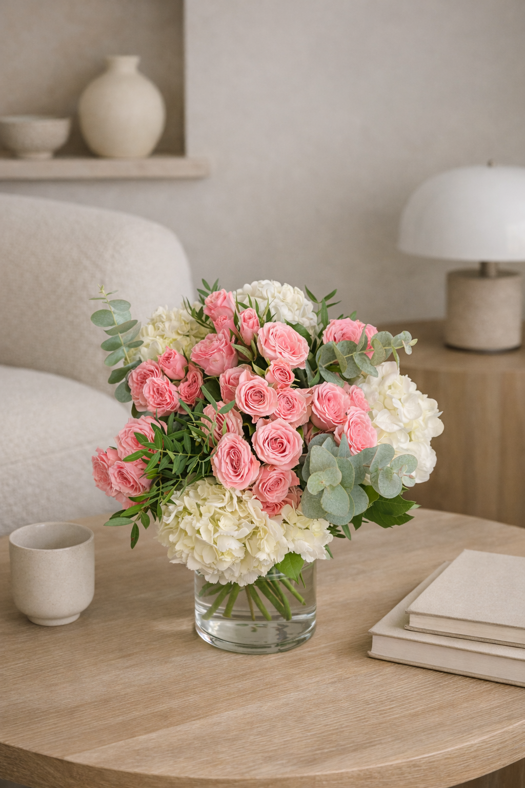 Luxury pink roses and white hydrangea arrangement in a clear glass vase styled in a contemporary interior in Montreal