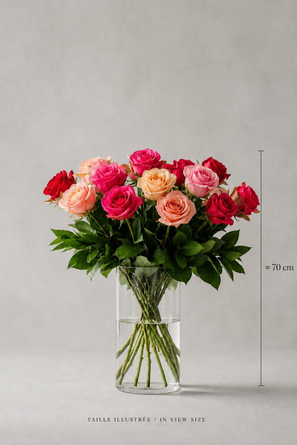 Peach, red, hot pink, and blush rose bouquet in a clear glass vase with a 70 cm size reference, styled as a refined floral arrangement Montreal image with clean editorial composition and polished product detail for flower delivery Montreal.