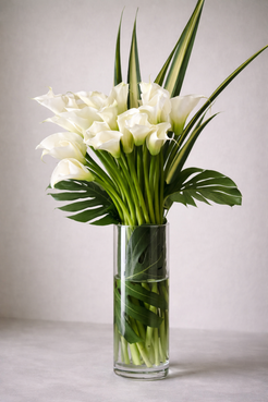 White calla lily bouquet 3/4 angle view, modern floral arrangement in clear glass vase, Montreal luxury florist design.