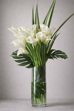 Luxury white calla lily bouquet in tall clear glass vase, contemporary vertical arrangement by Montreal high-end florist
