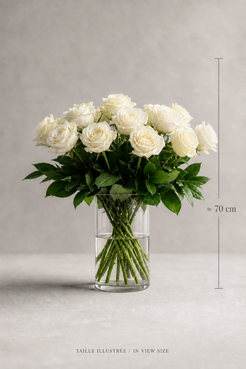 White cream Mondial rose bouquet in a clear glass vase with elegant size reference, shown as an editorial premium bouquet Montreal image with balanced front composition and fresh foliage.